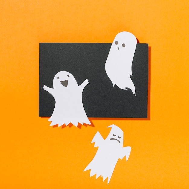 Free Photo funny ghosts on piece of black paper