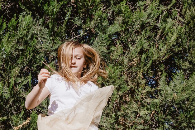 Free photo funny girl jumping near trees