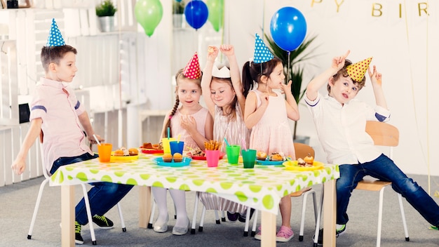 Funny kids in colored caps 