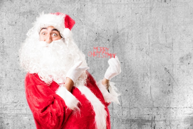 Funny man holding a merry christmas adornment