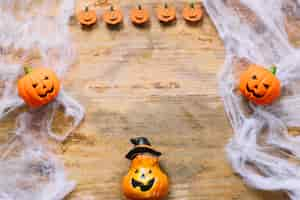 Free photo funny plastic pumpkins and artificial web