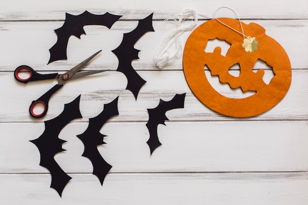 Funny pumpking and bats near scissors