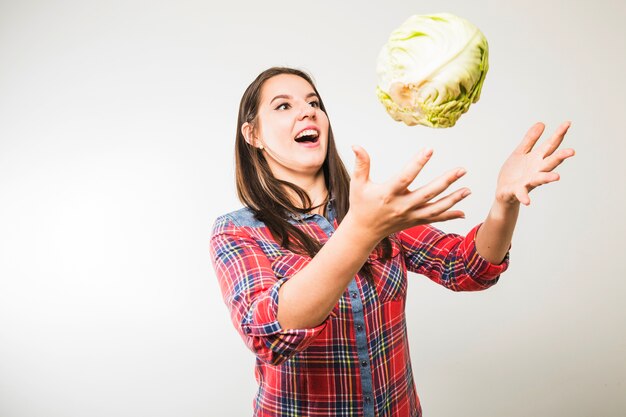 Funny woman catching cabbage