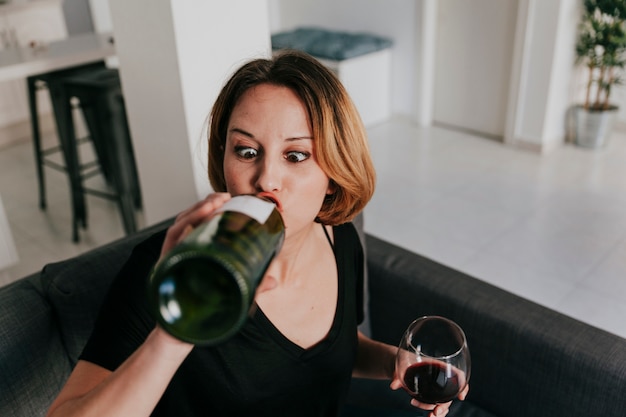 Funny woman drinking from bottle