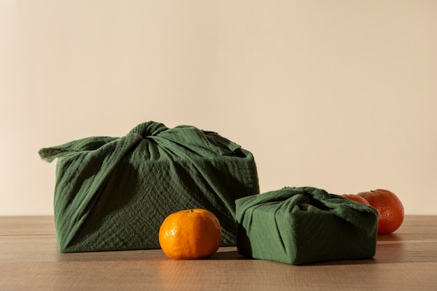 Free photo furoshiki package and oranges arrangement