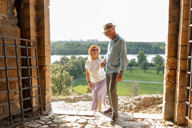 Gallant man helping his woman to climb