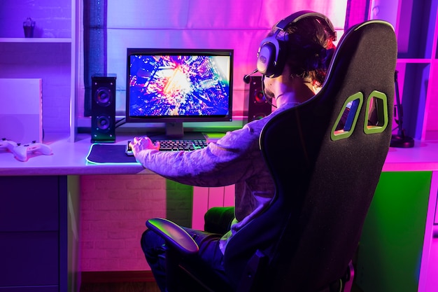 Free photo gamer playing indoors medium shot