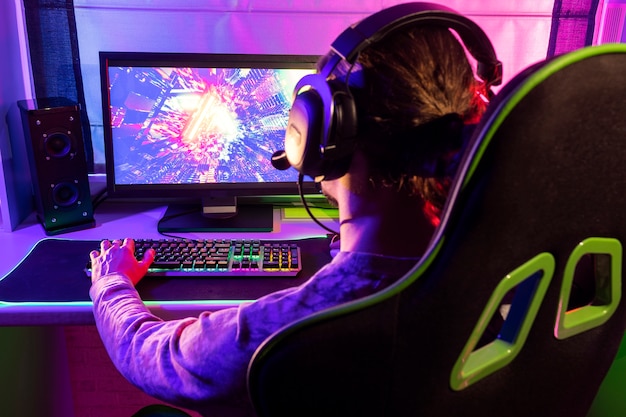 Free photo gamer playing indoors side view