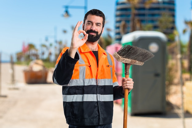 Garbage man making OK sign