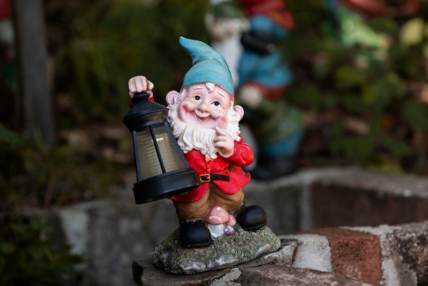 Free photo garden gnome with funny hat outdoors