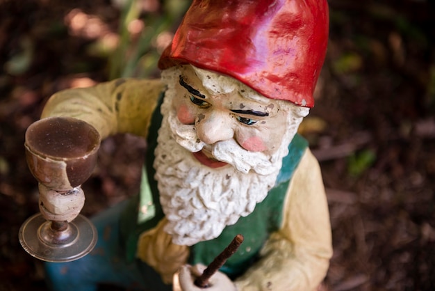 Free photo garden gnome with funny hat outdoors