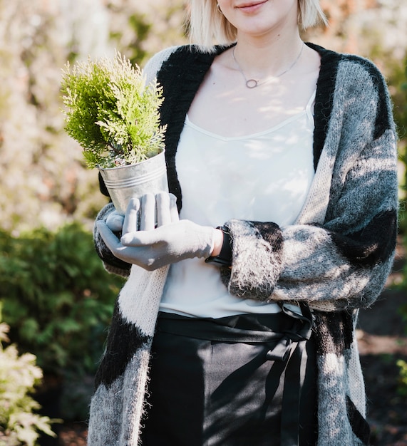 Free photo gardener holding plant