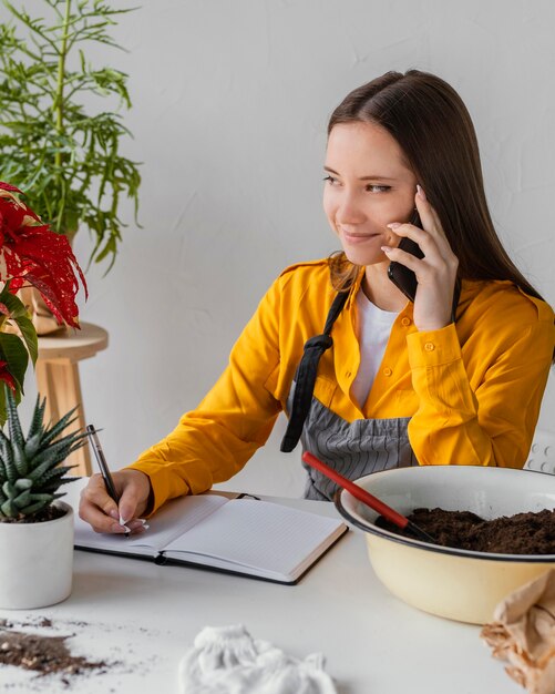 Gardener talking on the phone with a client