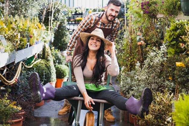 Gardeners having fun with wheelbarrow