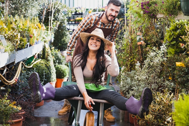 Gardeners having fun with wheelbarrow