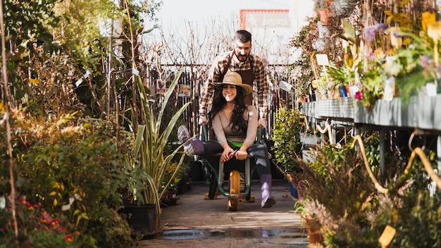 Gardeners riding wheelbarrow