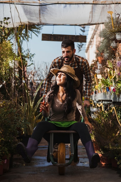 Free photo gardeners with wheelbarrow