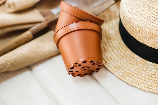 Gardening concept with flower pots and hat