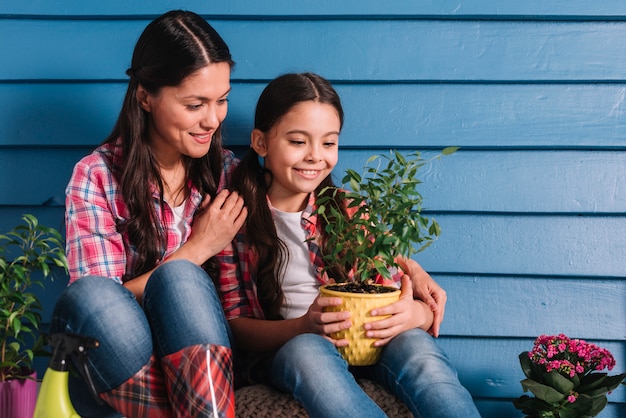 Gardening concept with mother and daughter