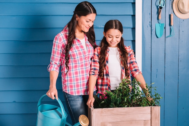 Free photo gardening concept with mother and daughter