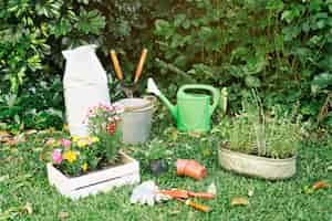 Free photo gardening inventory with flowerpots on grass