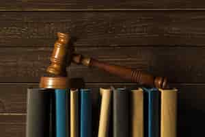 Free photo gavel with books on old wooden desk