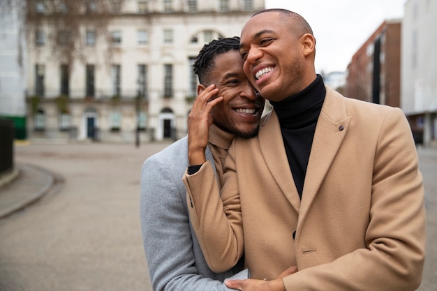 Free photo gay couple being affectionate outdoors in the city