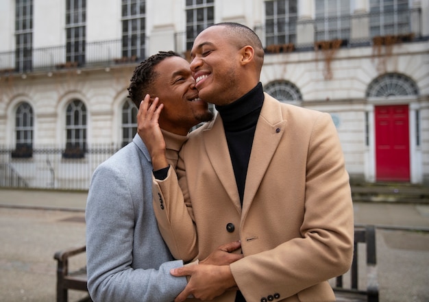 Free photo gay couple being affectionate outdoors in the city