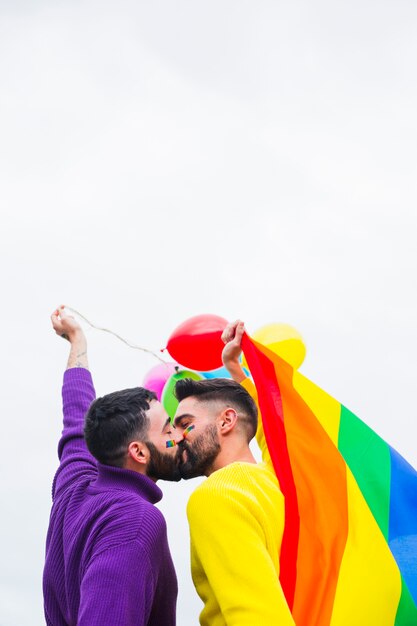 Gay sweethearts kissing on LGBT pride parade