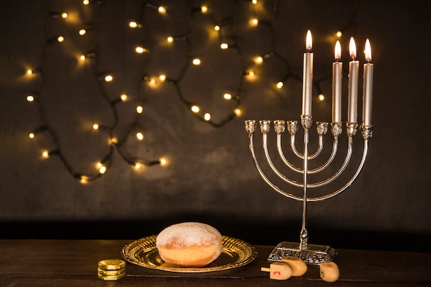 Free Photo gelt and dreidels lying near doughnut and menorah