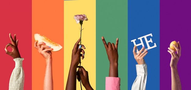 Gender fluid people hands on rainbow background