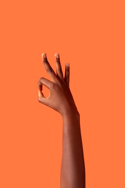 Free Photo gender fluid person hand isolated on orange