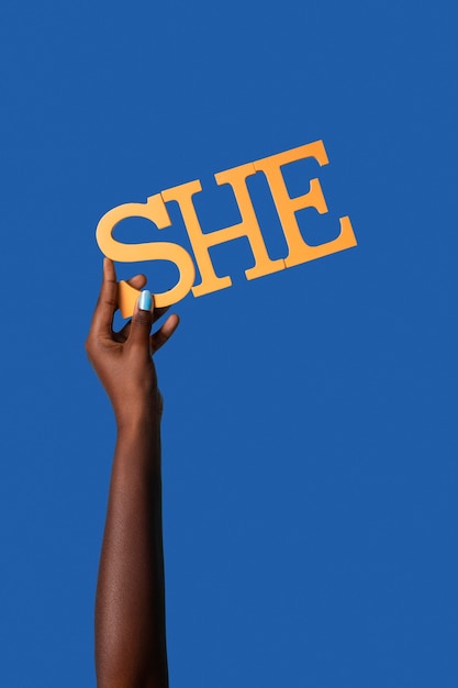 Gender fluid person holding a pronoun isolated on blue