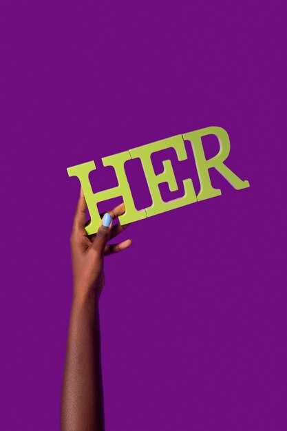 Gender fluid person holding a pronoun isolated on purple