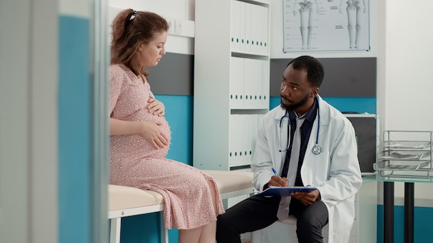 General practitioner attending consultation and taking notes