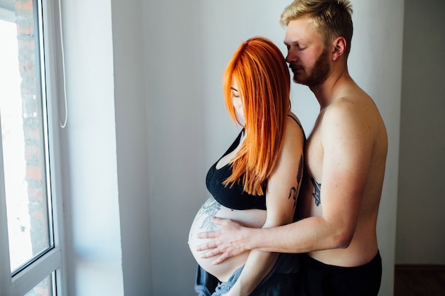 Free photo gentle couple embracing inside