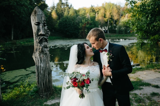 Free Photo gentle newlyweds posing in park