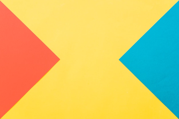 Free Photo geometric background in yellow, red and blue