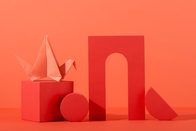 Free Photo geometric paper shapes on coral background