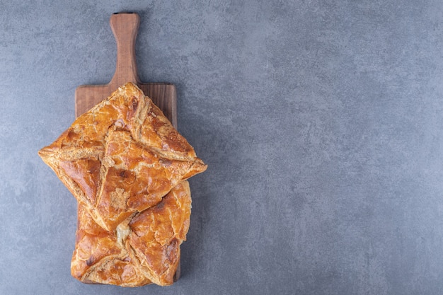 Free photo georgian penovani khachapuri layered on a board on marble table.