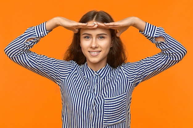 Free Photo gestures and body language. successful happy hopeful young student girl in striped shirt smiling broadly