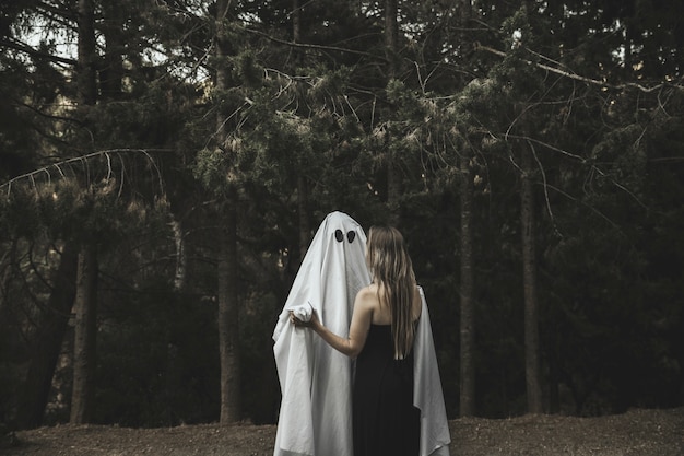 Ghost and lady embracing in park