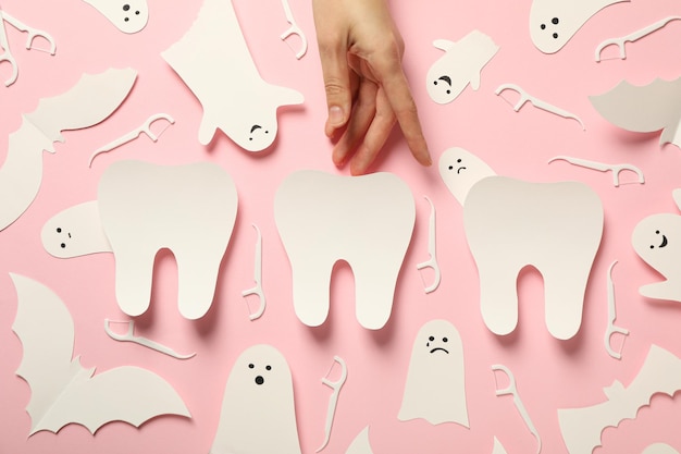 Free photo ghost teeth on pink background flat lay