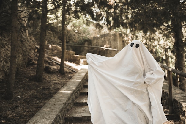 Ghost with spreading hands on steps in park