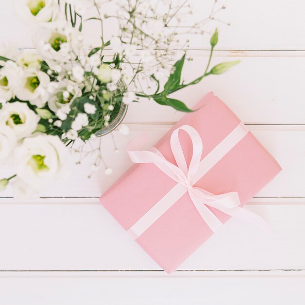 Gift box with flowers in vase