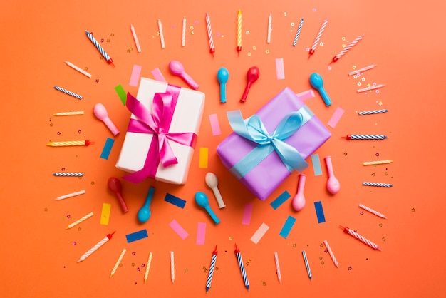 Gift boxes surrounded by candles and balloons