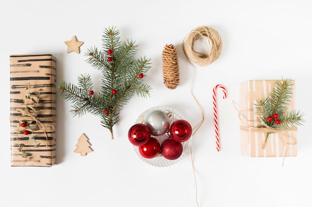 Free photo gift boxes with fir tree branch and shiny baubles