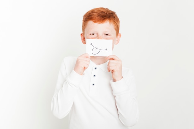 Free Photo ginger boy holding card in front of face