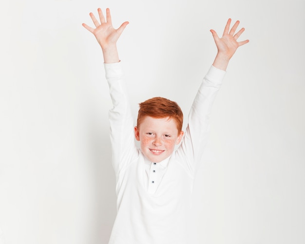 Free Photo ginger boy raising his hands