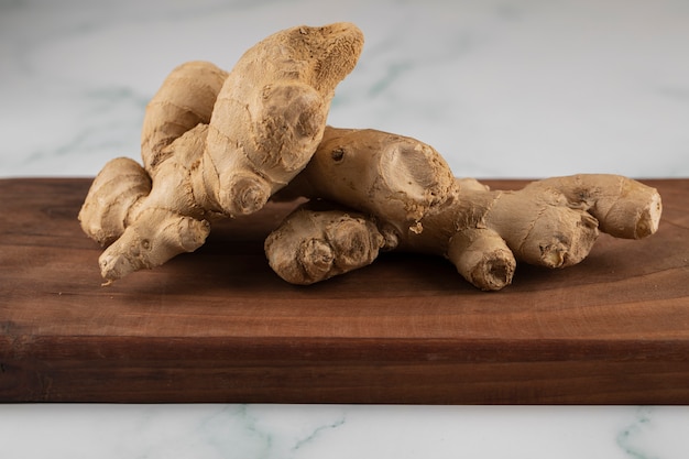 Ginger plants on a wooden board.